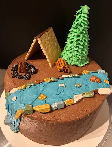 Camping themed chocolate birthday cake with fondant tent and campfire by Robin Bakes in Glendale AZ
